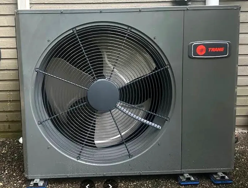 Low-profile Trane outdoor unit installed tight to the home