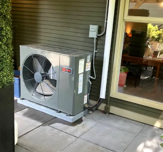 Compact outdoor unit fitted neatly beside a patio