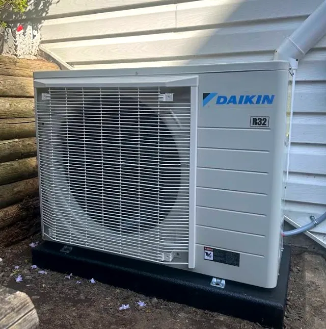 Daikin ductless outdoor unit installed on a ground pad